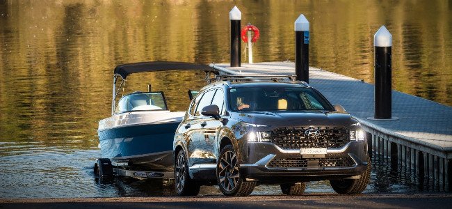 Best SUVs with High Towing Capacity in NZ - Pictured here a Hyundai Santa Fe SUV launching a boat.