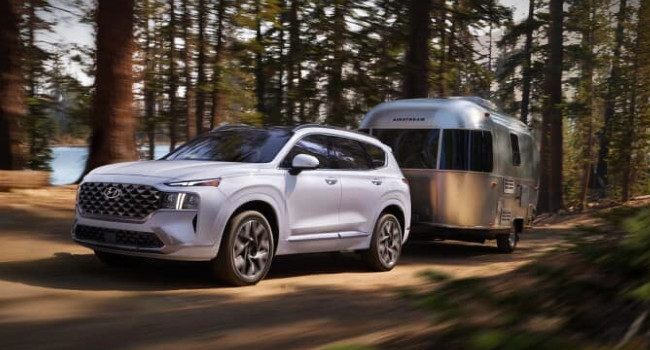 Best SUVs with High Towing Capacity in NZ - Pictured here a Hyundai Santa Fe SUV towing a caravan.