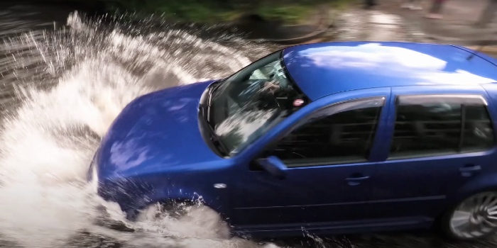 VW Golf driving through floodwater too fast