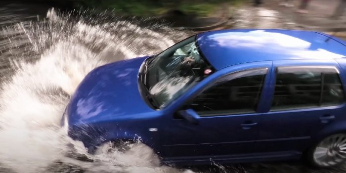 VW Golf driving through floodwater too fast