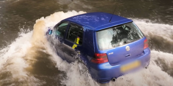 VW Golf driving through floodwater too fast