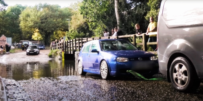 VW Golf being towed out of floodwater