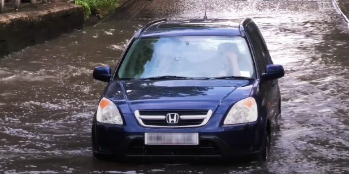 Honda CRV stranded after driving into floodwater too fast