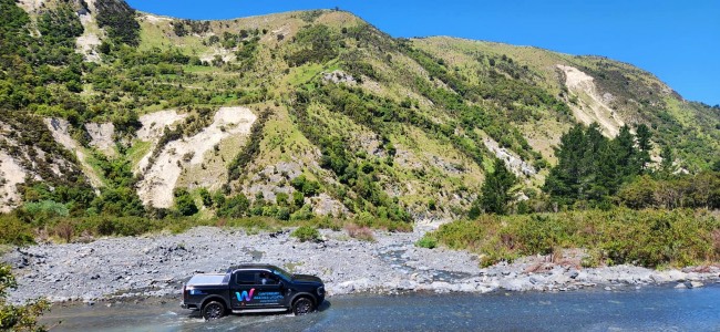 Russ driving the Canterbury Weather Updates ute through the Jordan River in Kaikoura High Country